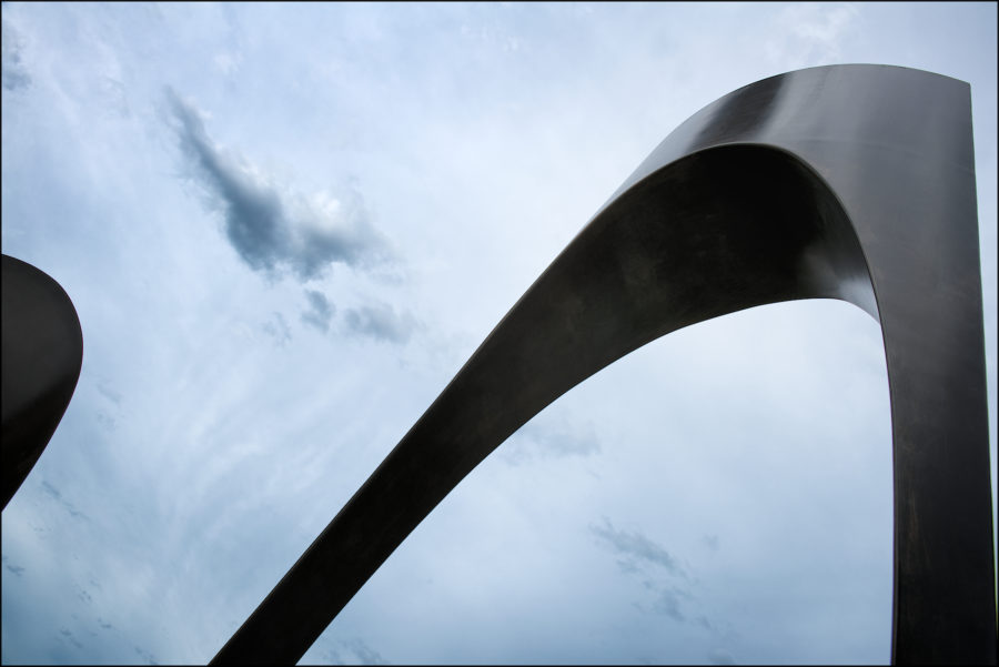 Sculpture in Park Against Blue Cloudy Background Copyright Bret Doss Visual Media Strategy